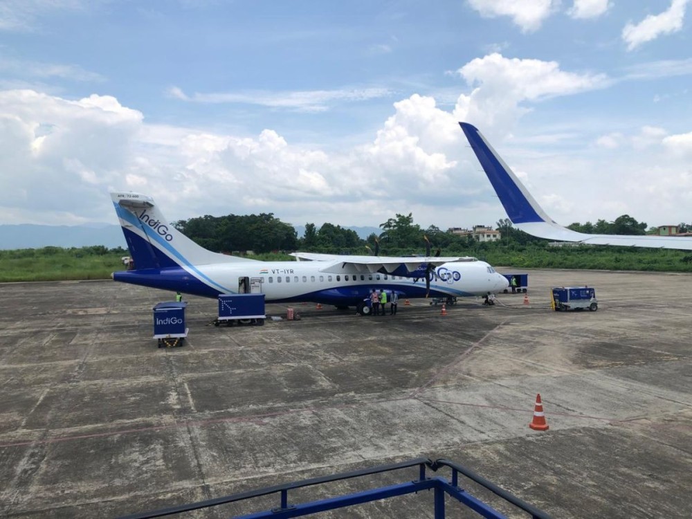 READY FOR TAKE-OFF, STUCK ON GROUND: An aircraft prepares for departure at Dimapur Airport as ground crew work near the terminal and runway. Calls for the release of land required for the long-delayed expansion of Nagaland’s only air link have resurfaced in the recent past. (Morung File Photo)